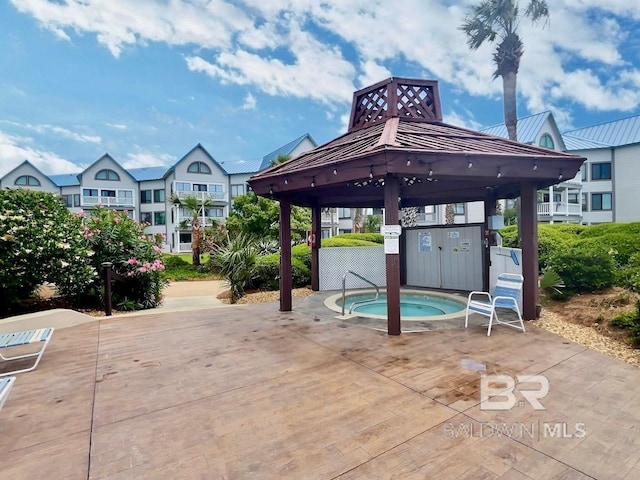 view of pool featuring a gazebo and a community hot tub