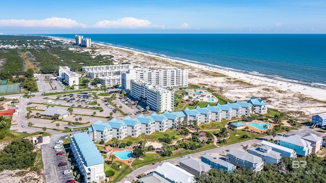 bird's eye view with a water view and a beach view