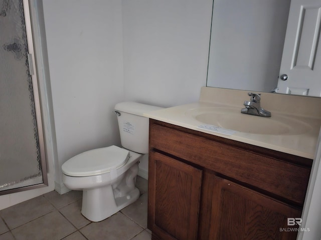 bathroom with toilet, vanity, tile patterned floors, and an enclosed shower