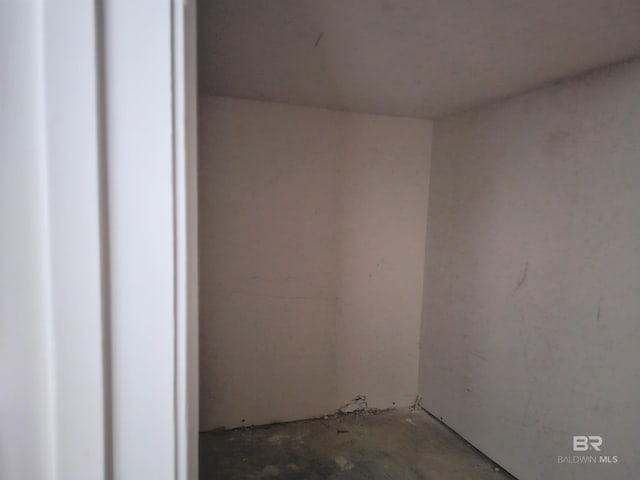 empty room with concrete flooring