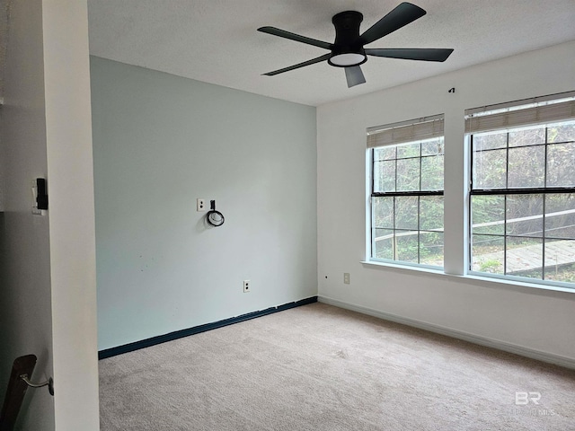 empty room with light colored carpet and ceiling fan