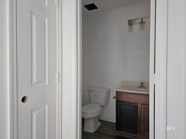 bathroom featuring vanity, hardwood / wood-style flooring, and toilet