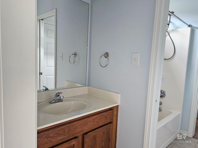 bathroom featuring tile patterned floors, vanity, and tub / shower combination