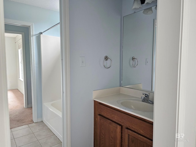 bathroom featuring tile patterned flooring, vanity, and a textured ceiling