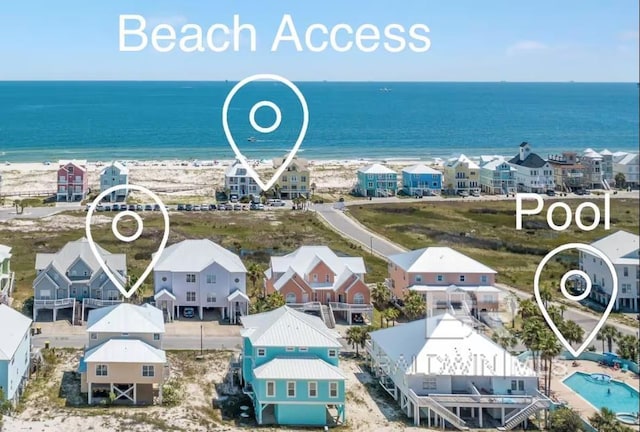 birds eye view of property with a water view and a view of the beach