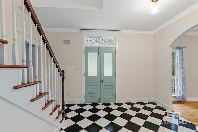 foyer with ornamental molding and hardwood / wood-style floors