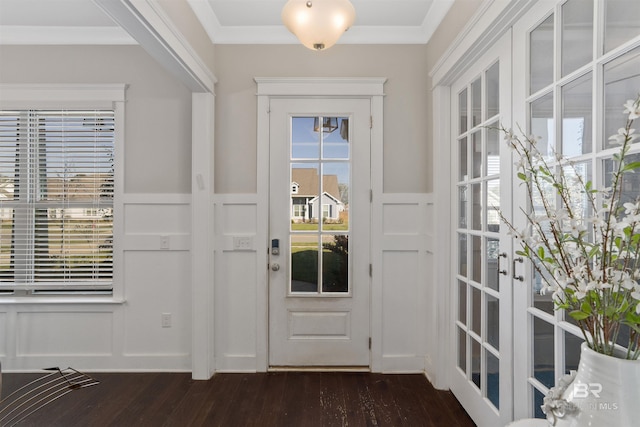 doorway to outside with ornamental molding, wainscoting, french doors, a decorative wall, and dark wood-style flooring