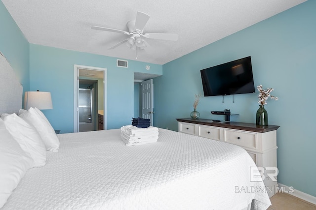 bedroom with baseboards, a ceiling fan, visible vents, and a textured ceiling