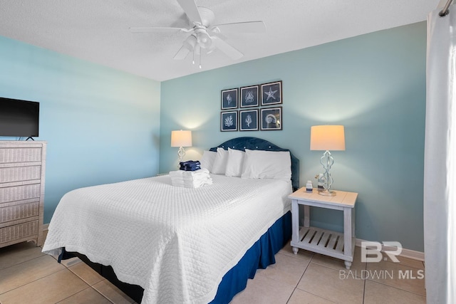 bedroom with baseboards, a ceiling fan, and tile patterned flooring