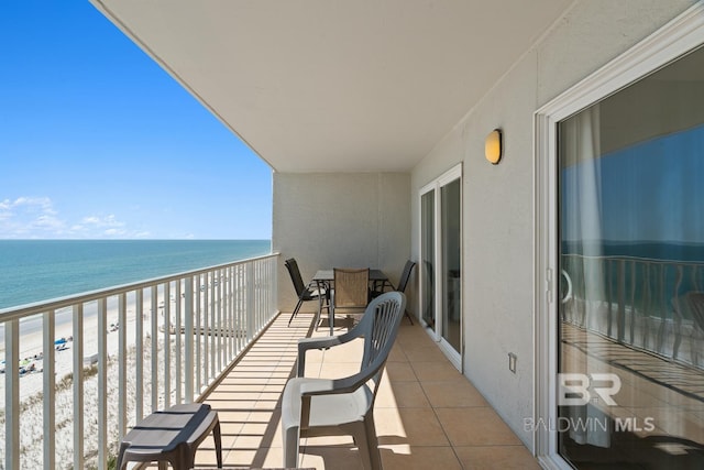 balcony featuring a beach view and a water view