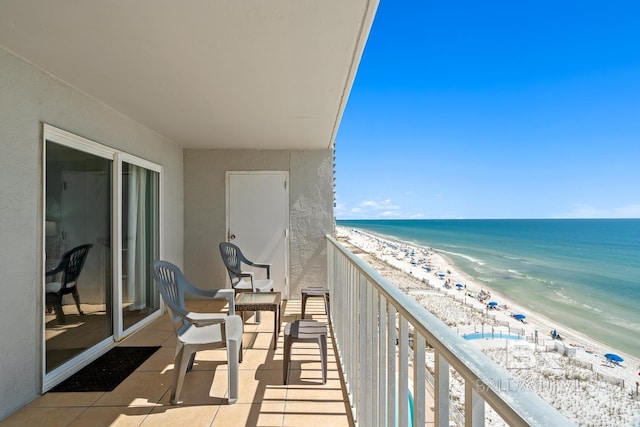 balcony featuring a water view and a beach view