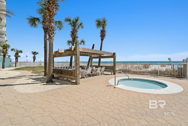 view of swimming pool featuring a patio area, a water view, a pergola, and fence