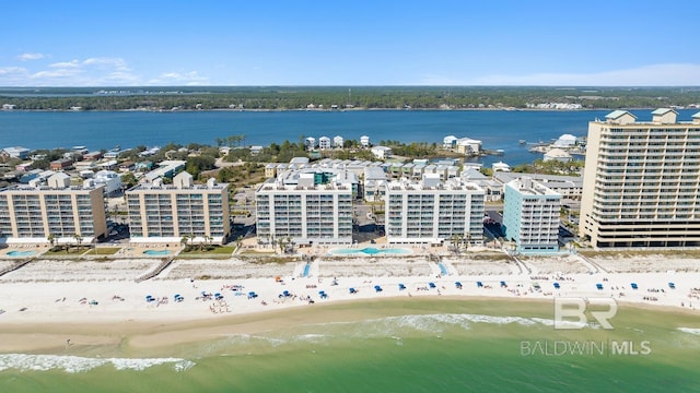 drone / aerial view featuring a water view and a view of the beach