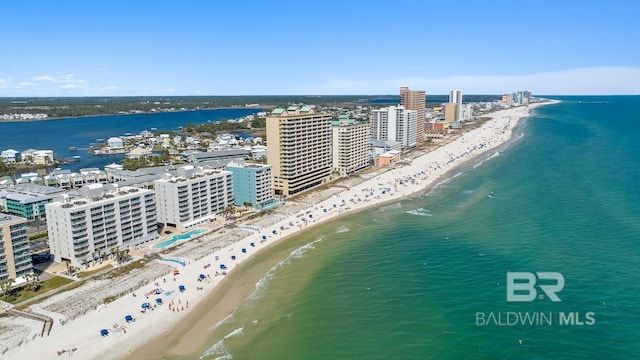 drone / aerial view featuring a view of city, a view of the beach, and a water view