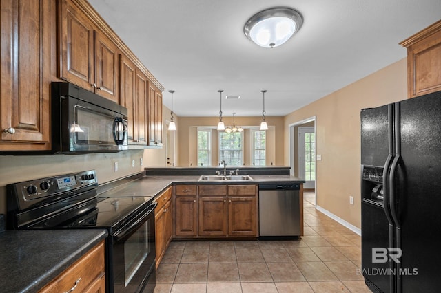 kitchen with black appliances, a sink, brown cabinetry, and light tile patterned floors