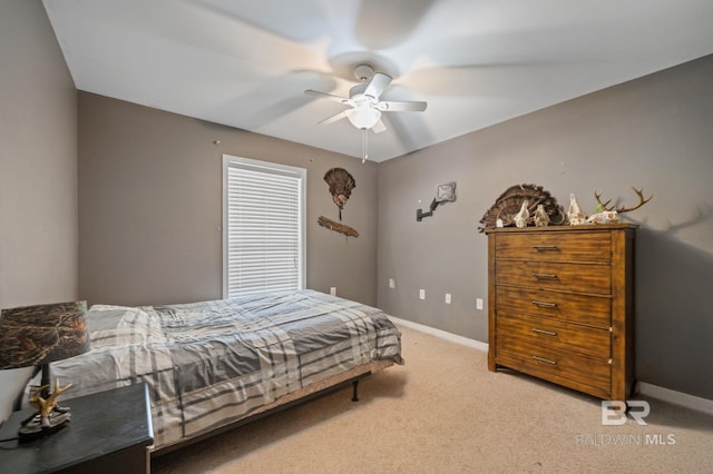 carpeted bedroom with baseboards and a ceiling fan