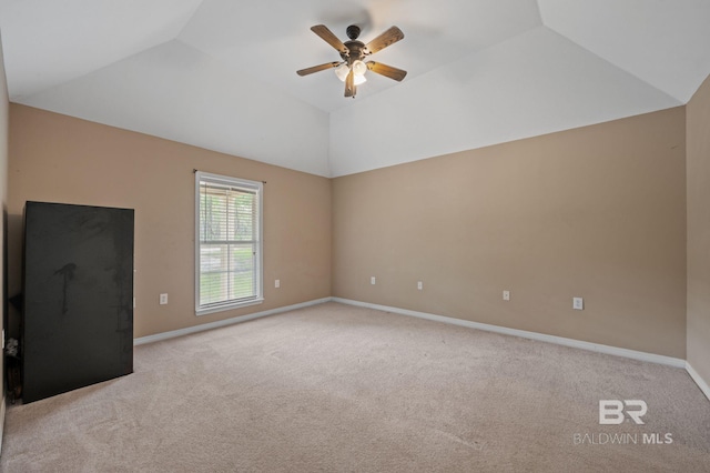unfurnished living room with carpet, ceiling fan, vaulted ceiling, and baseboards