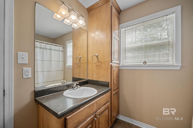 bathroom featuring vanity and baseboards