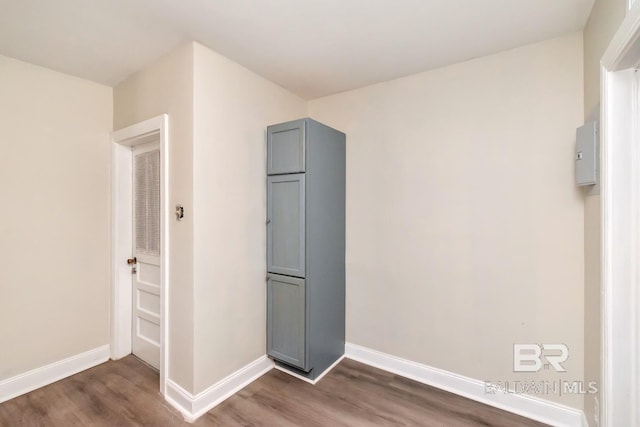 unfurnished bedroom with dark wood-style flooring and baseboards