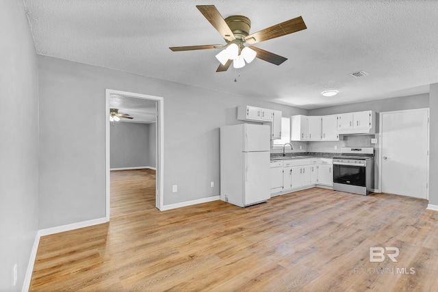3304 Armond St, Mobile, AL 36605 - kitchen featuring white appliances, ceiling fan, a textured ceiling, light wood-style flooring, and white cabinets