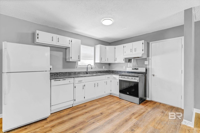 3304 Armond St, Mobile, AL 36605 - kitchen with white appliances, dark countertops, light wood finished floors, a textured ceiling, and white cabinets