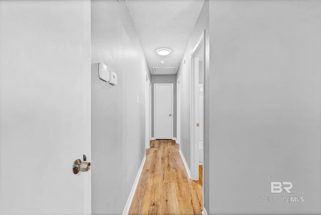 3304 Armond St, Mobile, AL 36605 - hall with a textured ceiling, light wood-type flooring, and attic access