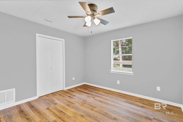 3304 Armond St, Mobile, AL 36605 - unfurnished bedroom with a closet, wood finished floors, ceiling fan, and a textured ceiling