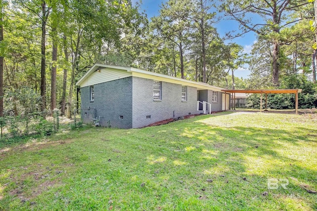 3304 Armond St, Mobile, AL 36605 - rear view of house with crawl space, brick siding, and a carport