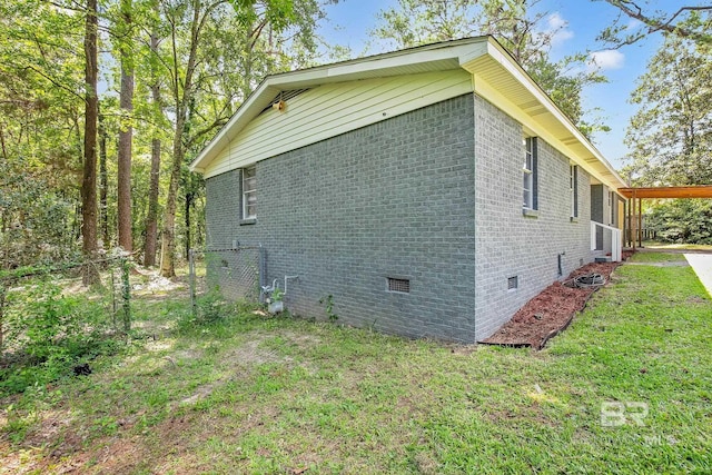 3304 Armond St, Mobile, AL 36605 - view of home's exterior featuring crawl space, brick siding, and a yard