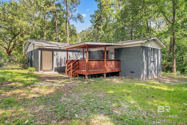 3304 Armond St, Mobile, AL 36605 - rear view of house featuring crawl space, brick siding, a lawn, a deck, and an outdoor structure