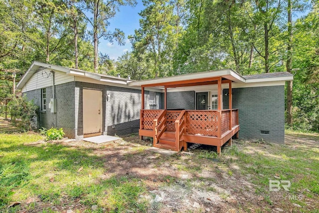3304 Armond St, Mobile, AL 36605 - back of property with brick siding, crawl space, and a deck
