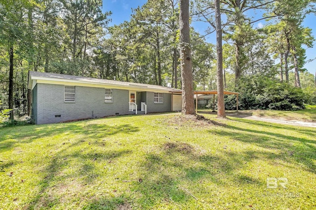 3304 Armond St, Mobile, AL 36605 - back of house with crawl space, a yard, brick siding, and an attached carport