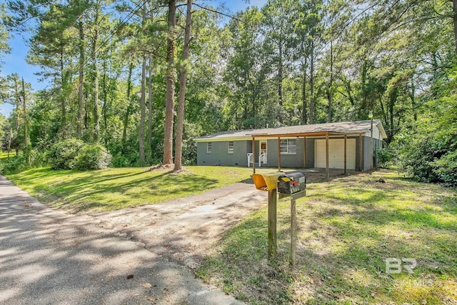 3304 Armond St, Mobile, AL 36605 - view of front of home with dirt driveway, a front lawn, a garage, and an outbuilding
