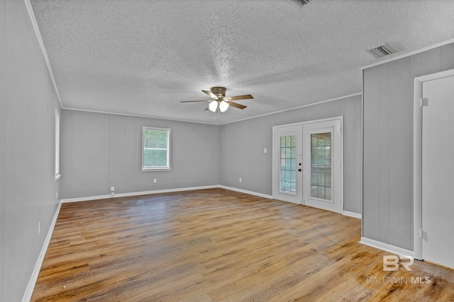 3304 Armond St, Mobile, AL 36605 - empty room with ceiling fan, wood finished floors, ornamental molding, a textured ceiling, and french doors