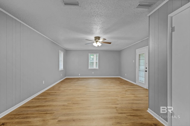 3304 Armond St, Mobile, AL 36605 - spare room with light wood-style flooring, a textured ceiling, a ceiling fan, and crown molding