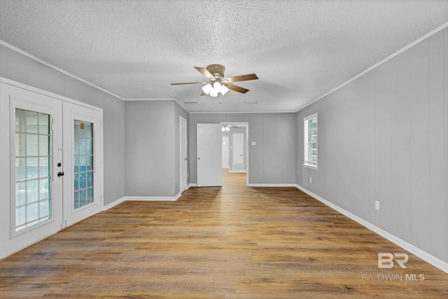 3304 Armond St, Mobile, AL 36605 - unfurnished room featuring french doors, a ceiling fan, a textured ceiling, wood finished floors, and crown molding