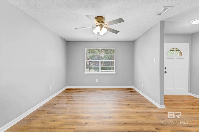 3304 Armond St, Mobile, AL 36605 - unfurnished room with healthy amount of natural light, a textured ceiling, a ceiling fan, and light wood-style floors