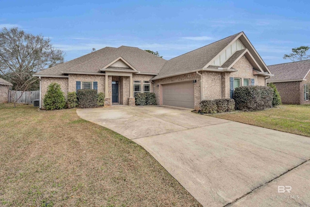 view of front facade featuring cooling unit, a garage, and a front lawn