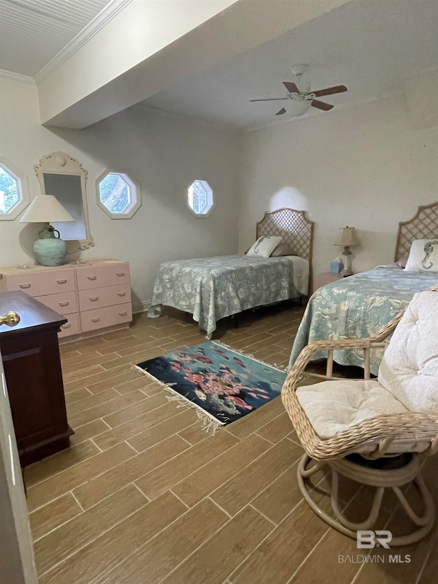 bedroom with dark hardwood / wood-style flooring, ornamental molding, and ceiling fan