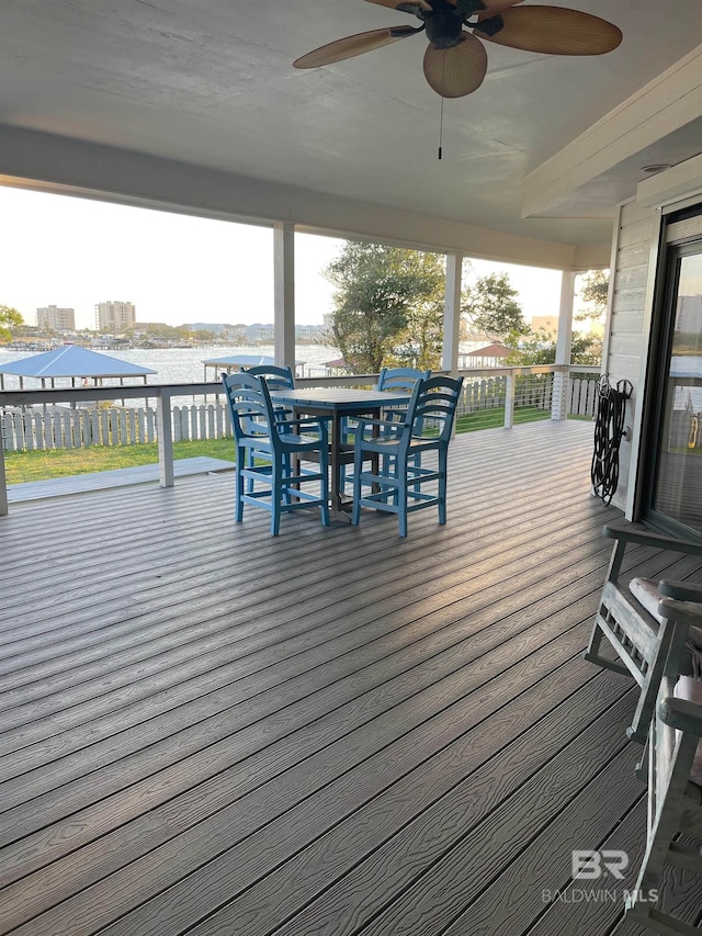 wooden terrace featuring a water view and ceiling fan