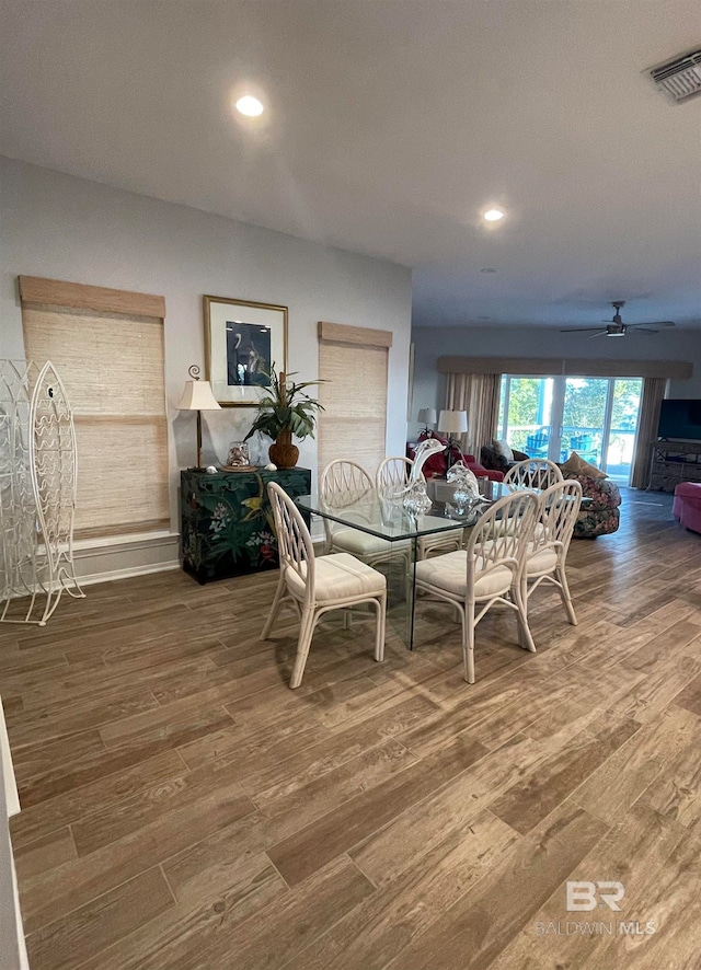 dining space featuring ceiling fan and wood-type flooring