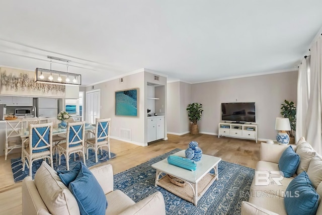 living room featuring ornamental molding and light wood-type flooring