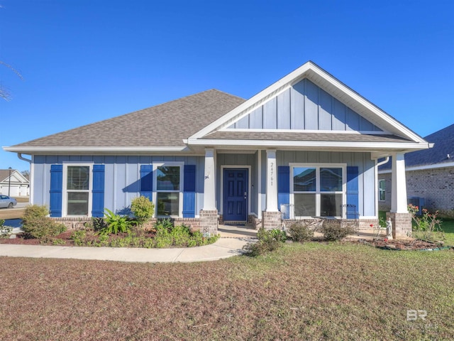 craftsman-style house with covered porch and a front yard