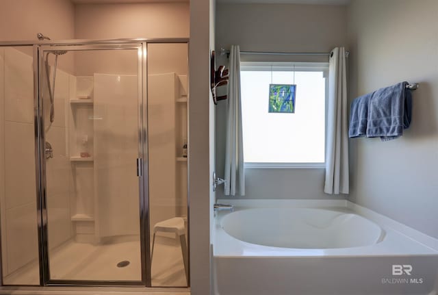 bathroom with shower with separate bathtub