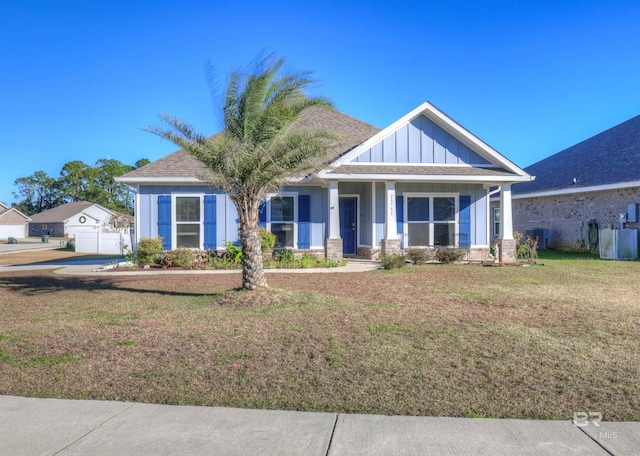 view of front of property featuring central air condition unit and a front yard