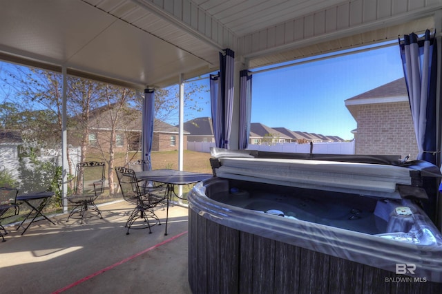 sunroom with wood ceiling and a hot tub