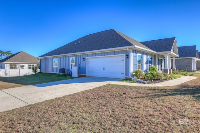 single story home featuring a front yard, a garage, and cooling unit