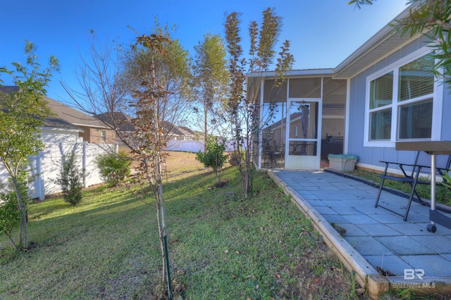 view of yard featuring a patio and a sunroom