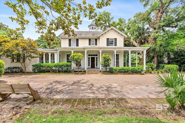 view of front facade with a porch and french doors