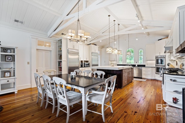 dining area with an inviting chandelier, vaulted ceiling with beams, dark wood-type flooring, and sink